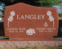 Pence Monument Company works with its customers to create an unlimited variety of memorials. This granite upright monument is an example of an option for a double monument with roses and the rings of marriage. 
