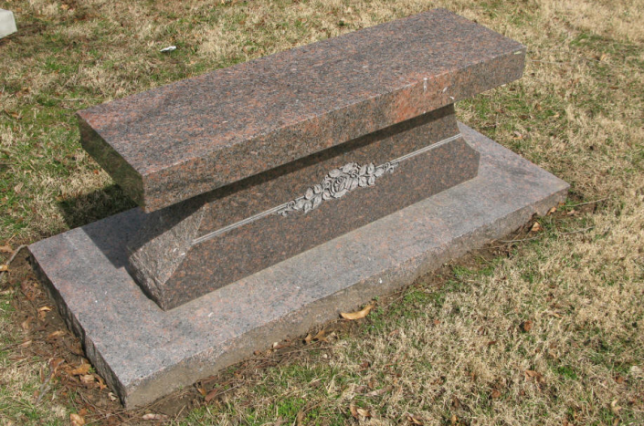 This granite bench memorial with sketched roses honors a special  family member.