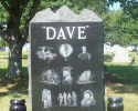 This granite monument is an example of a single upright monument with matching double vases and highlights the special moments in this man's life. Bring in your photos and let our artist customize your purchase. 