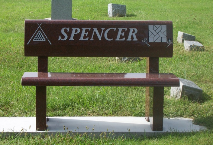 A memorial bench such as this one can be placed in a private garden or in a public cemetery. This bench monument has been customized and polished.
