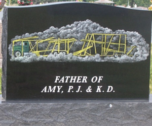 Black headstone with custom engraving of semi truck 