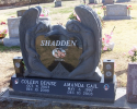 This double monument is protected by guardian angles with vases on each side. Call today to ask about the other options for custom monument choices. 