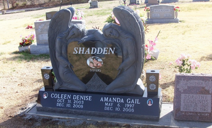 This double monument is protected by guardian angles with vases on each side. Call today to ask about the other options for custom monument choices. 
